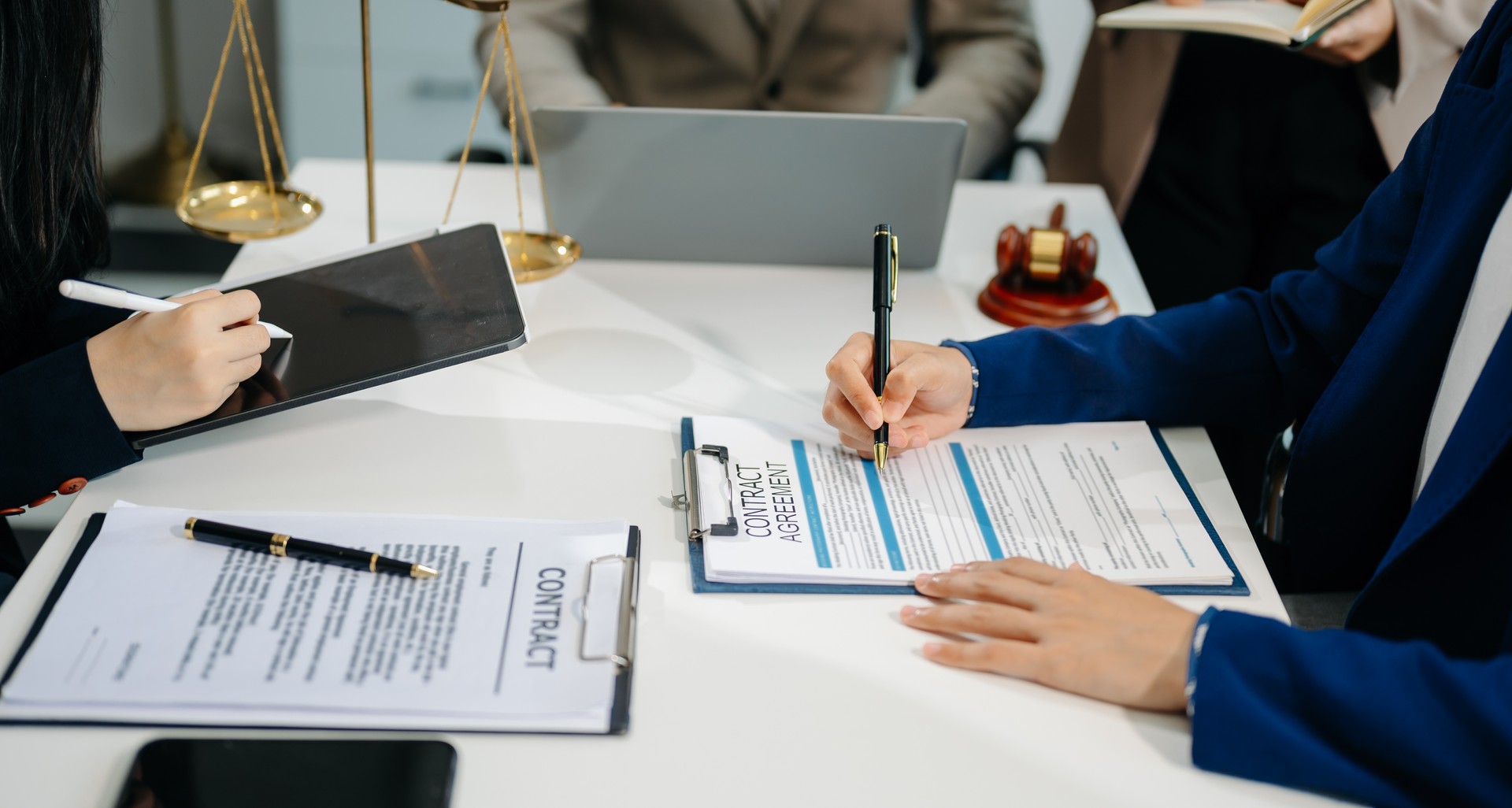 business people and lawyers discussing contract papers sitting at the table. Concepts of law, advice, legal services.