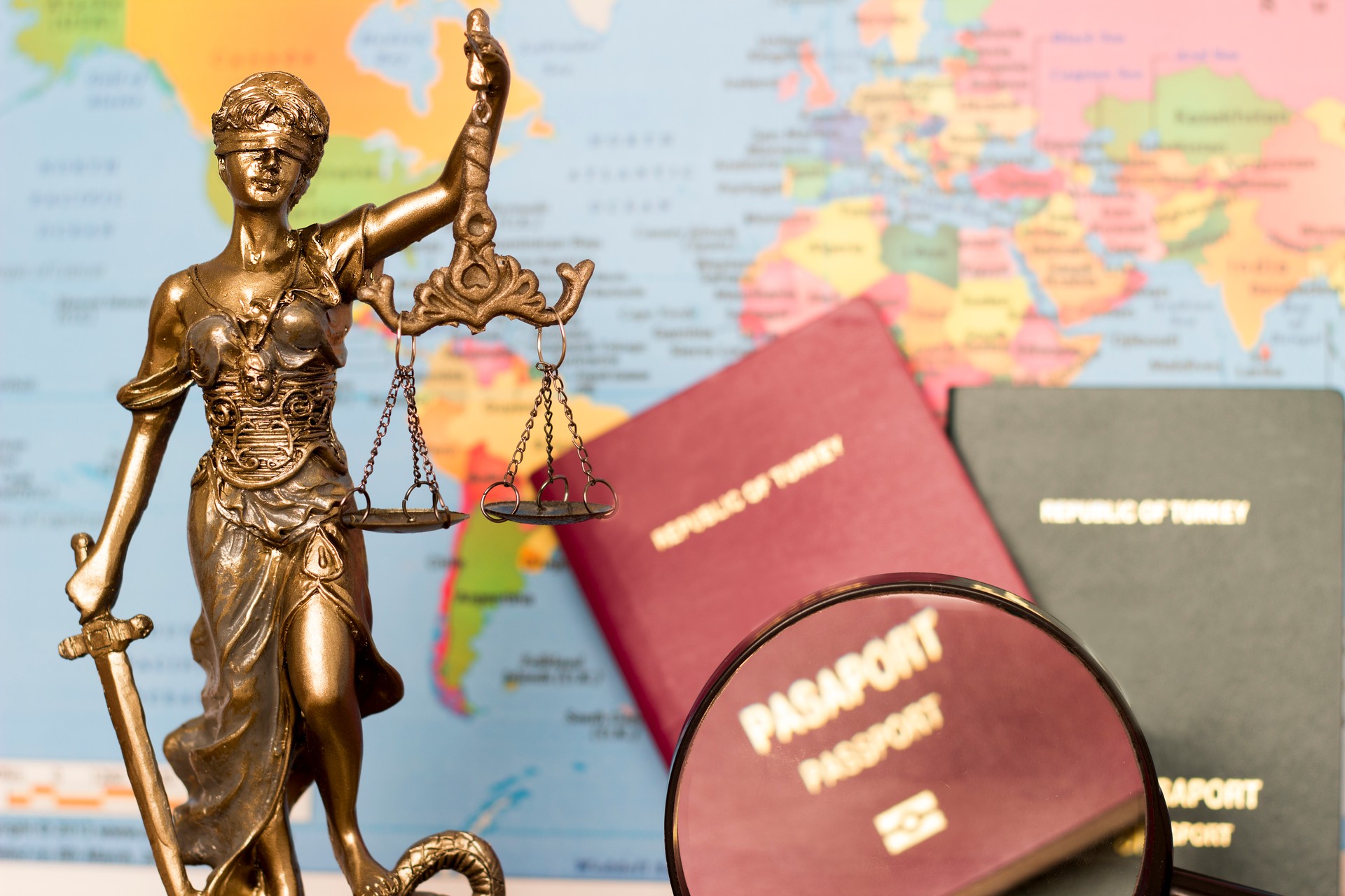 Law concept, statue, magnifying glass, passport and world map. Travel